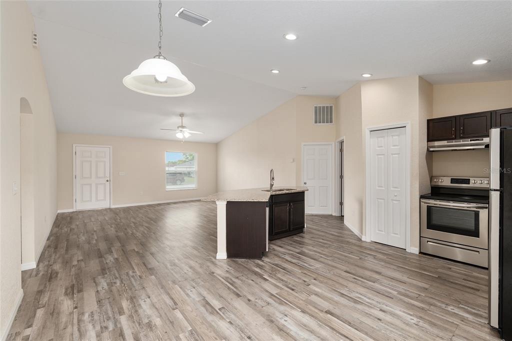 22 Juniper Loop Circle Ocala, FL 34480 - Photo 22 of 53 a kitchen with stainless steel appliances granite countertop a refrigerator and a stove top oven