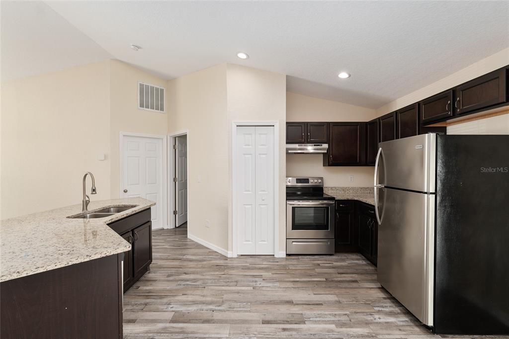 22 Juniper Loop Circle Ocala, FL 34480 - Photo 25 of 53 a kitchen with a refrigerator sink and stove