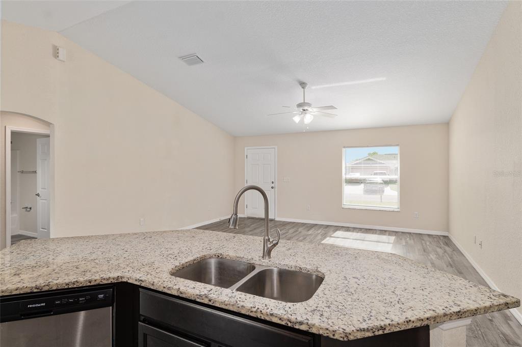 22 Juniper Loop Circle Ocala, FL 34480 - Photo 27 of 53 a kitchen with granite countertop a sink and cabinets