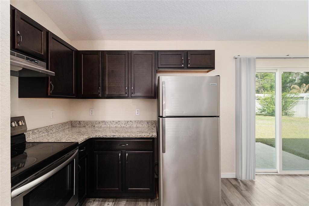 22 Juniper Loop Circle Ocala, FL 34480 - Photo 28 of 53 a kitchen with a refrigerator and a sink