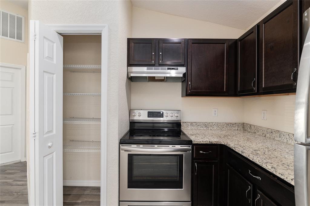 22 Juniper Loop Circle Ocala, FL 34480 - Photo 29 of 53 a kitchen with stainless steel appliances granite countertop a stove and a microwave