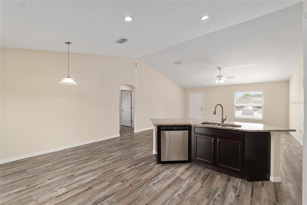 22 Juniper Loop Circle Ocala, FL 34480 - Photo 30 of 53 a kitchen with stainless steel appliances granite countertop a sink cabinets and wooden floor