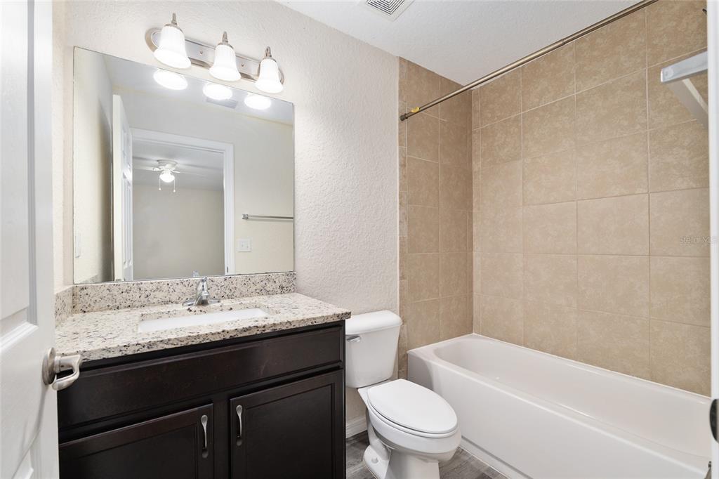 22 Juniper Loop Circle Ocala, FL 34480 - Photo 34 of 53 a bathroom with a granite countertop sink a toilet and shower