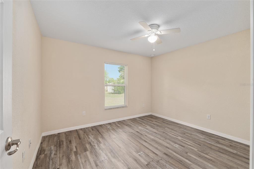 22 Juniper Loop Circle Ocala, FL 34480 - Photo 37 of 53 wooden floor in an empty room with a window