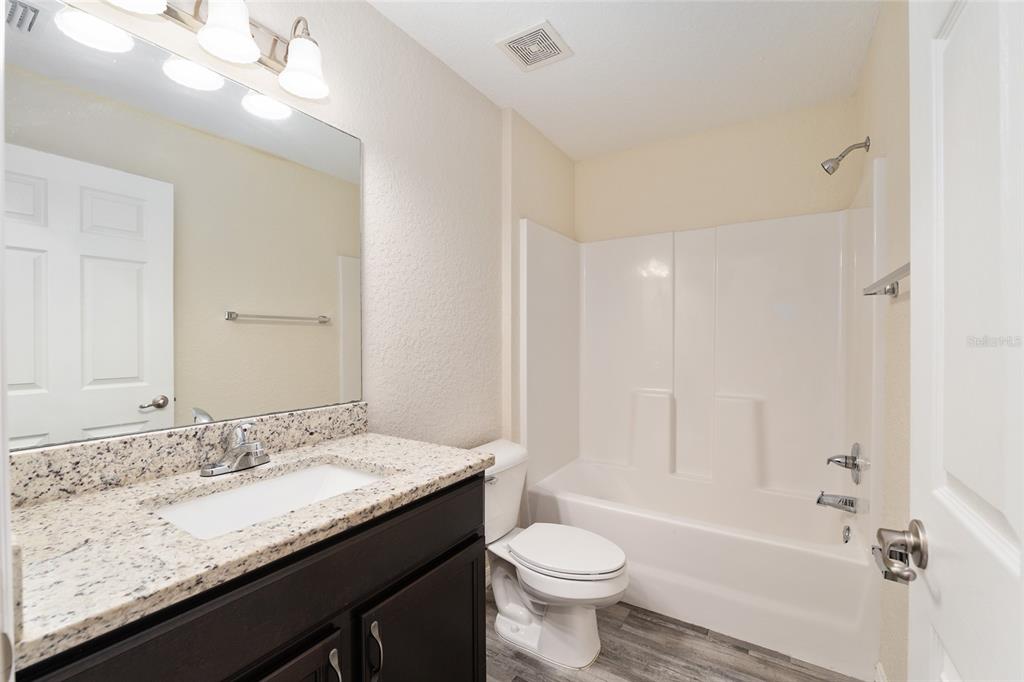 22 Juniper Loop Circle Ocala, FL 34480 - Photo 39 of 53 a bathroom with a granite countertop sink a toilet and bathtub