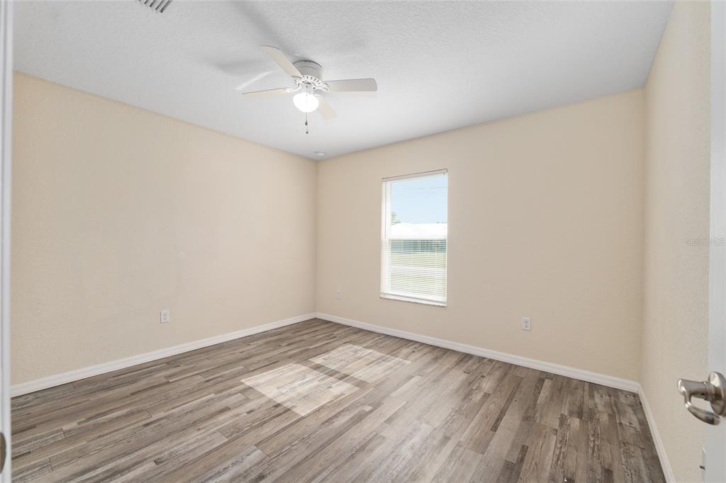 22 Juniper Loop Circle Ocala, FL 34480 - Photo 40 of 53 an empty room with wooden floor and windows