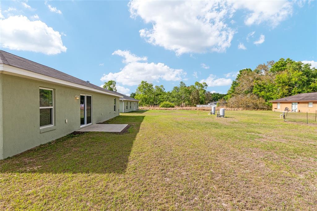 22 Juniper Loop Circle Ocala, FL 34480 - Photo 48 of 53 a view of a house with backyard and tree