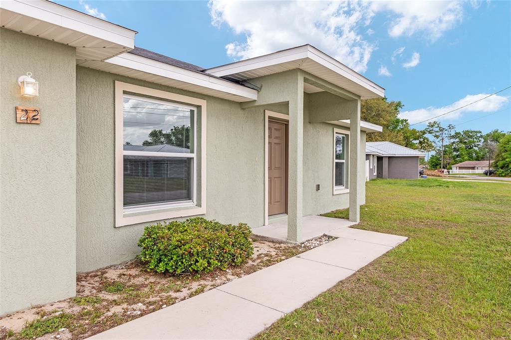 22 Juniper Loop Circle Ocala, FL 34480 - Photo 9 of 53 a front view of a house with garden