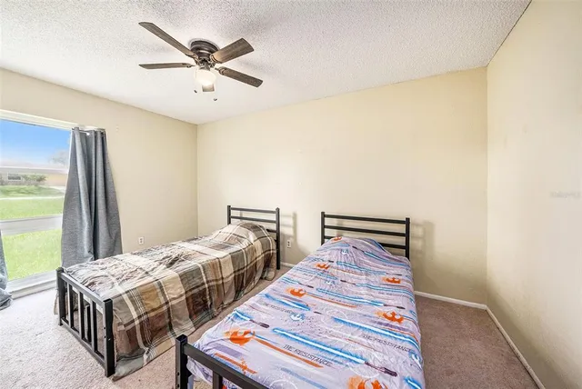 a bedroom with two beds and a chandelier