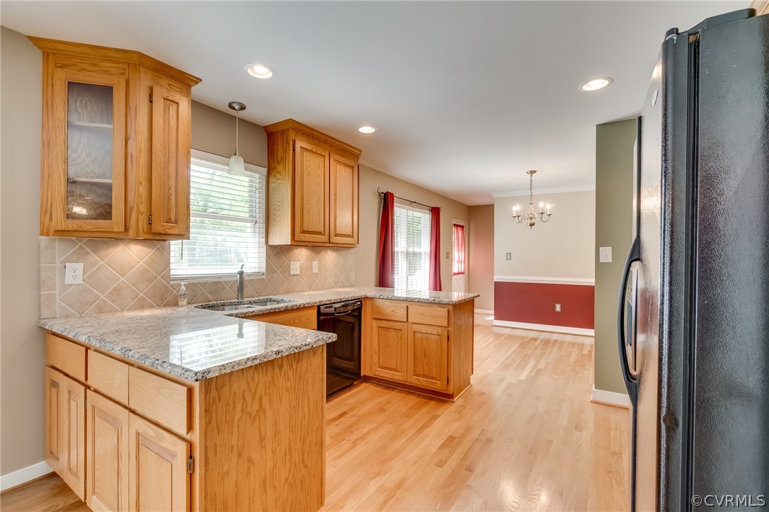 7512 Tangle Ridge Drive Mechanicsville, VA 23111 - Photo 6 of 23 a kitchen with granite countertop a sink stove refrigerator and wooden floor