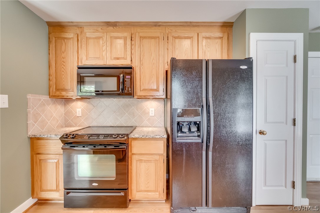 7512 Tangle Ridge Drive Mechanicsville, VA 23111 - Photo 7 of 23 a kitchen with a refrigerator stove and microwave