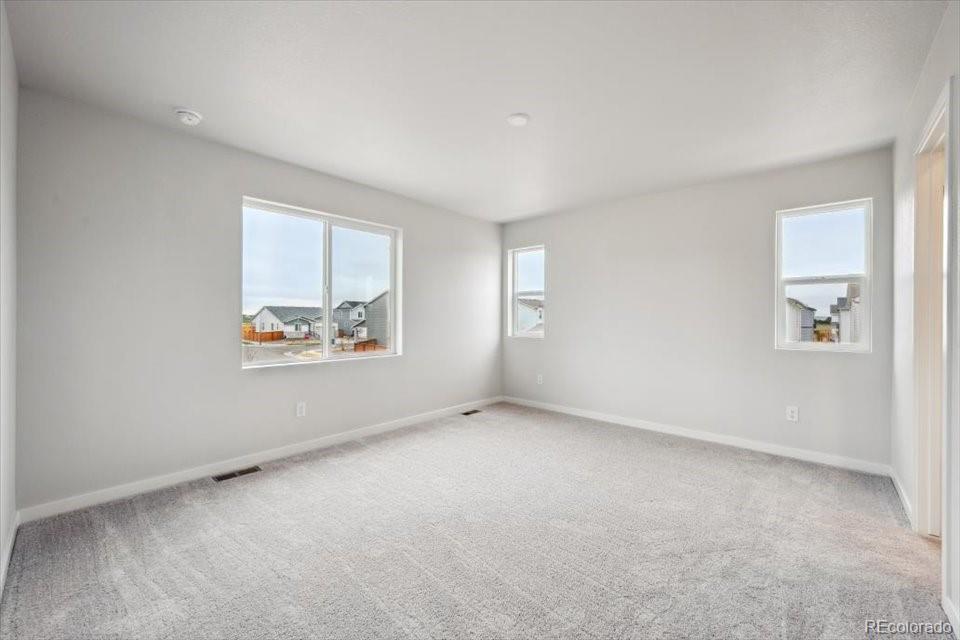 1382 Farmstead Street Brighton, CO 80601 - Photo 15 of 22 an empty room with windows