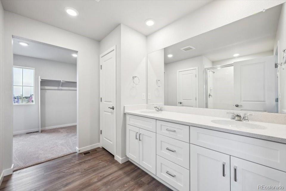 1382 Farmstead Street Brighton, CO 80601 - Photo 16 of 22 a spacious bathroom with a double vanity sink mirror and