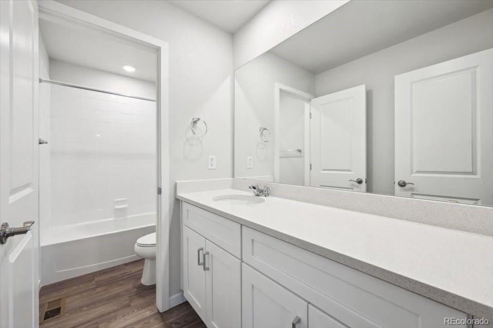 1382 Farmstead Street Brighton, CO 80601 - Photo 17 of 22 a bathroom with a sink a toilet and shower
