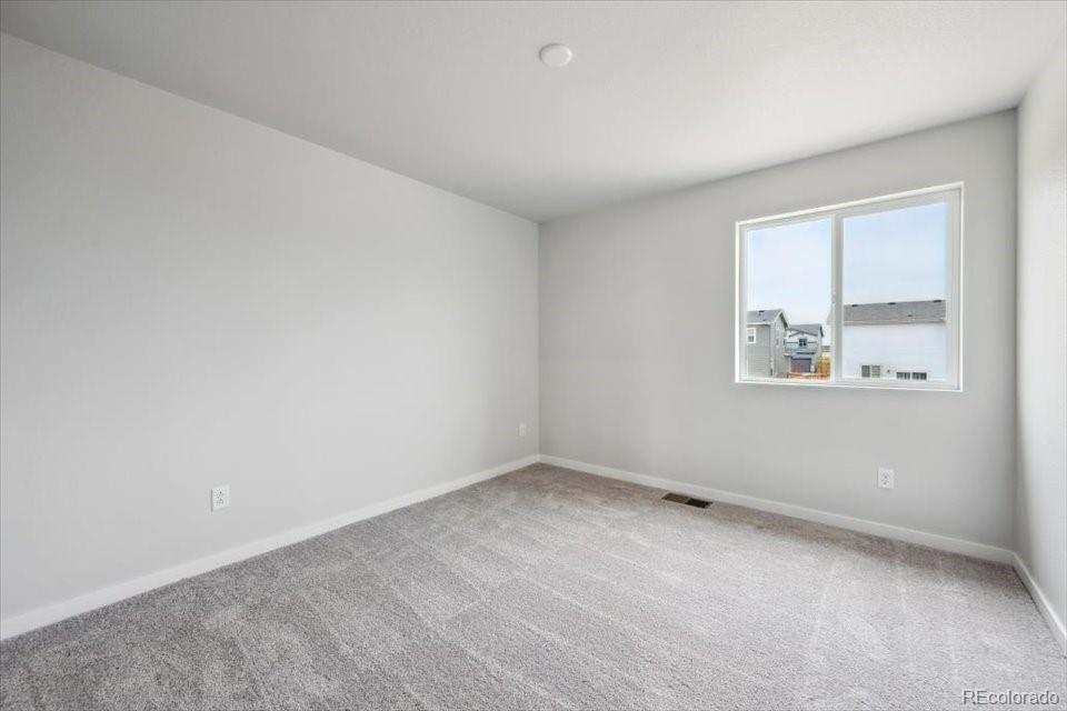 1382 Farmstead Street Brighton, CO 80601 - Photo 18 of 22 an empty room with a window