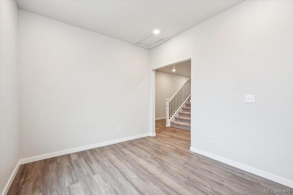 1382 Farmstead Street Brighton, CO 80601 - Photo 9 of 22 a view of a hallway with wooden floor