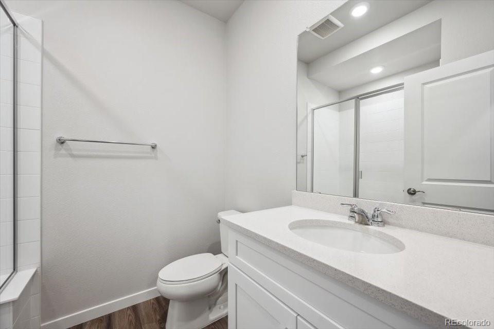 1382 Farmstead Street Brighton, CO 80601 - Photo 10 of 22 a bathroom with a sink toilet and a mirror