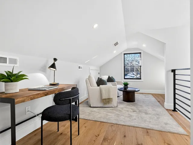 a spacious bedroom with a bed and a window