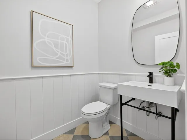 a living room with furniture a chandelier and a window