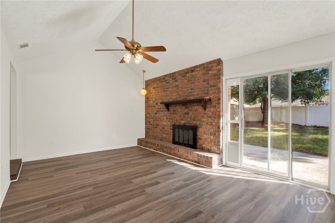 910 Old Mill Road Savannah, GA 31419 - Photo 15 of 41 Family room with cathedral ceiling, fan, brick fireplace and glass slider to the rear patio