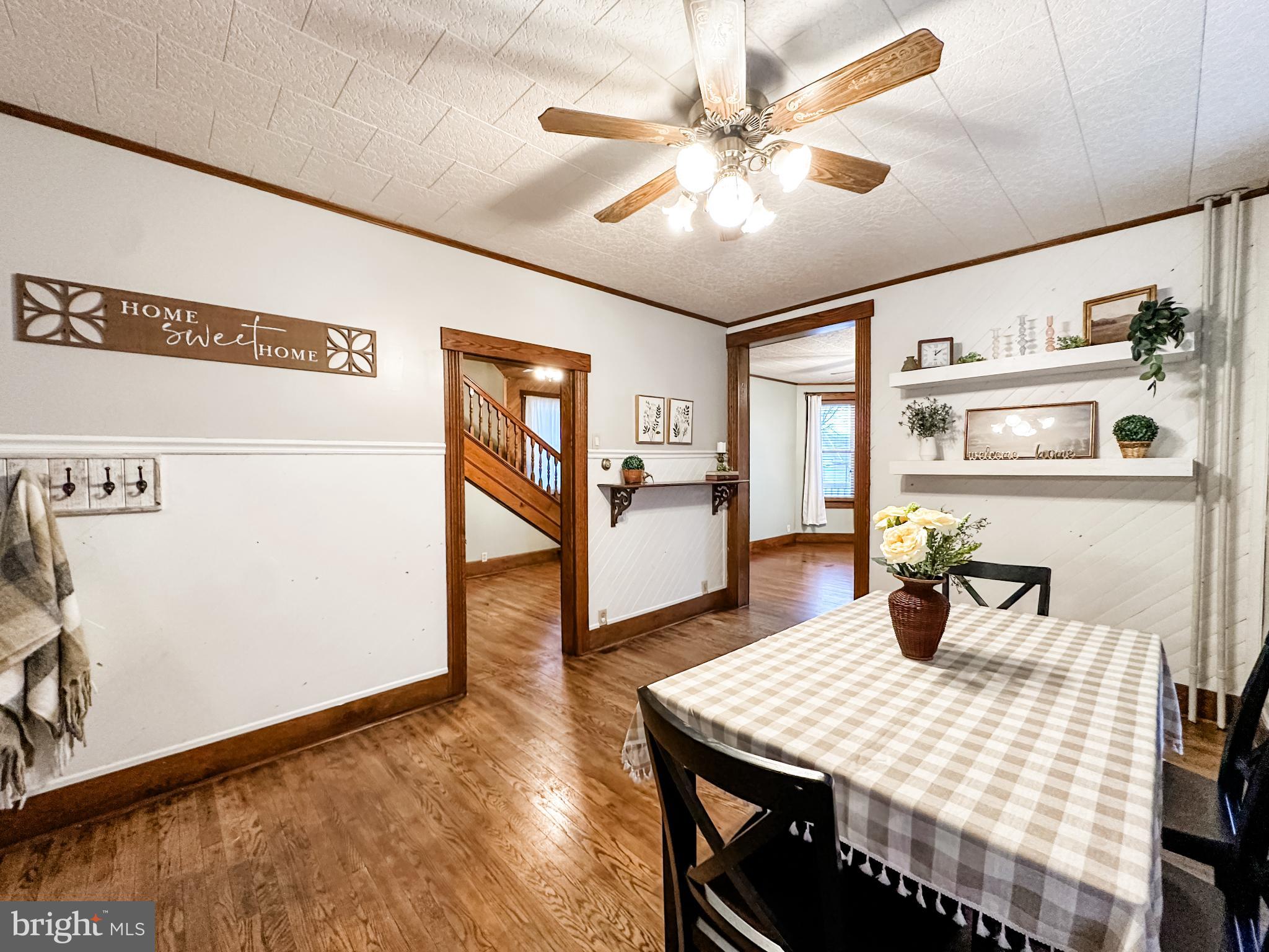 12812 New Row Rd N West Mount Savage, MD 21545 - Photo 12 of 32 a kitchen with stainless steel appliances kitchen island granite countertop a table chairs and a refrigerator