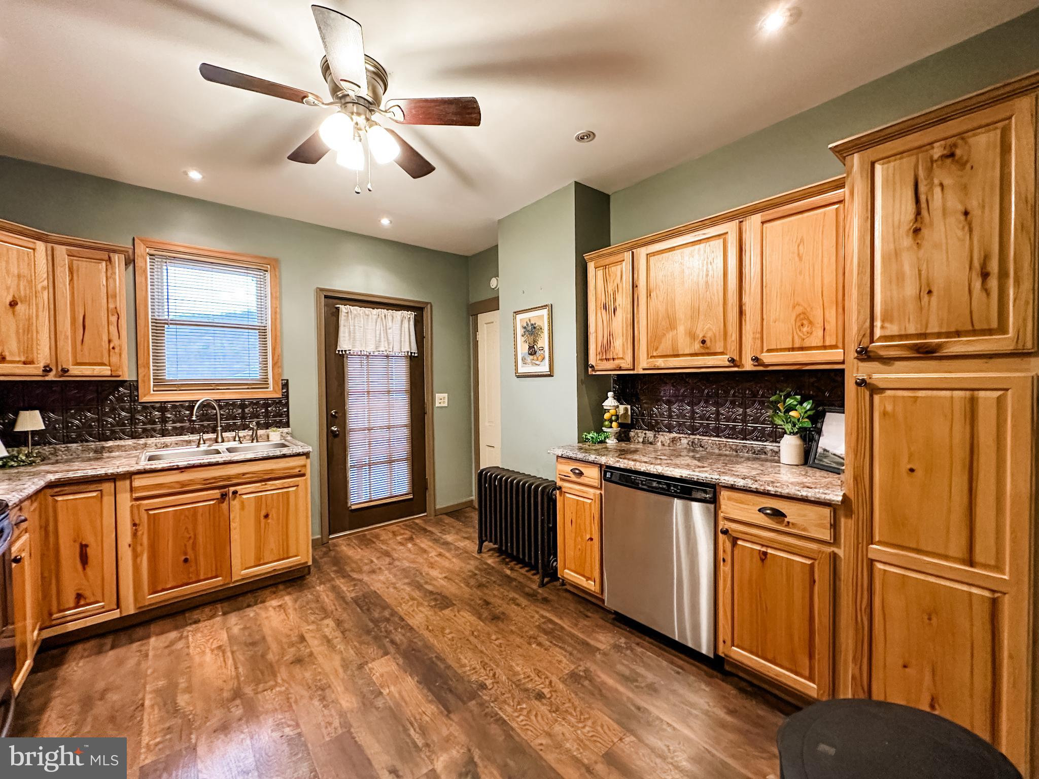 12812 New Row Rd N West Mount Savage, MD 21545 - Photo 14 of 32 a kitchen with stainless steel appliances granite countertop cabinets and a refrigerator
