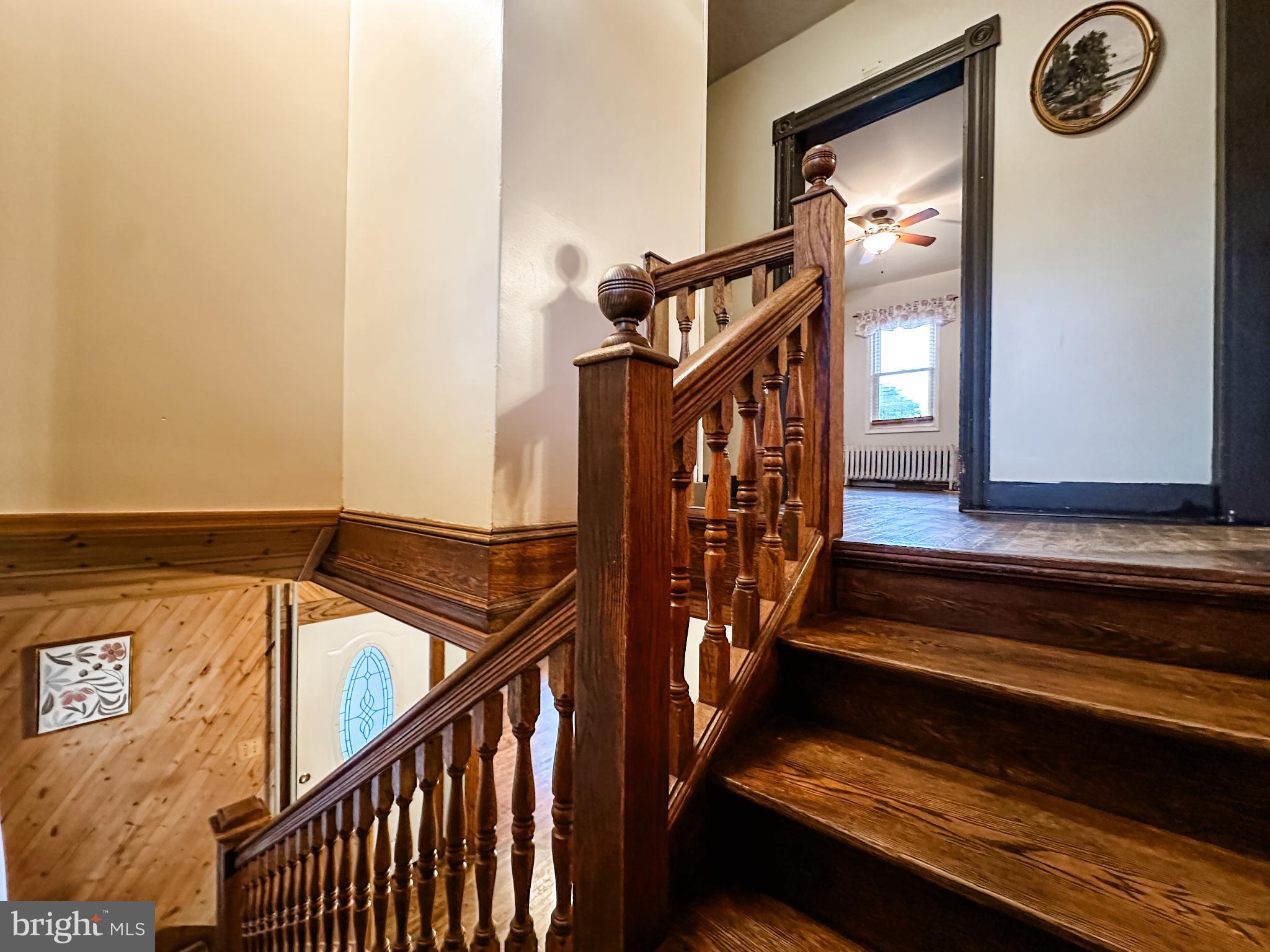 12812 New Row Rd N West Mount Savage, MD 21545 - Photo 18 of 32 a view of staircase with lots of frames on wall and a window