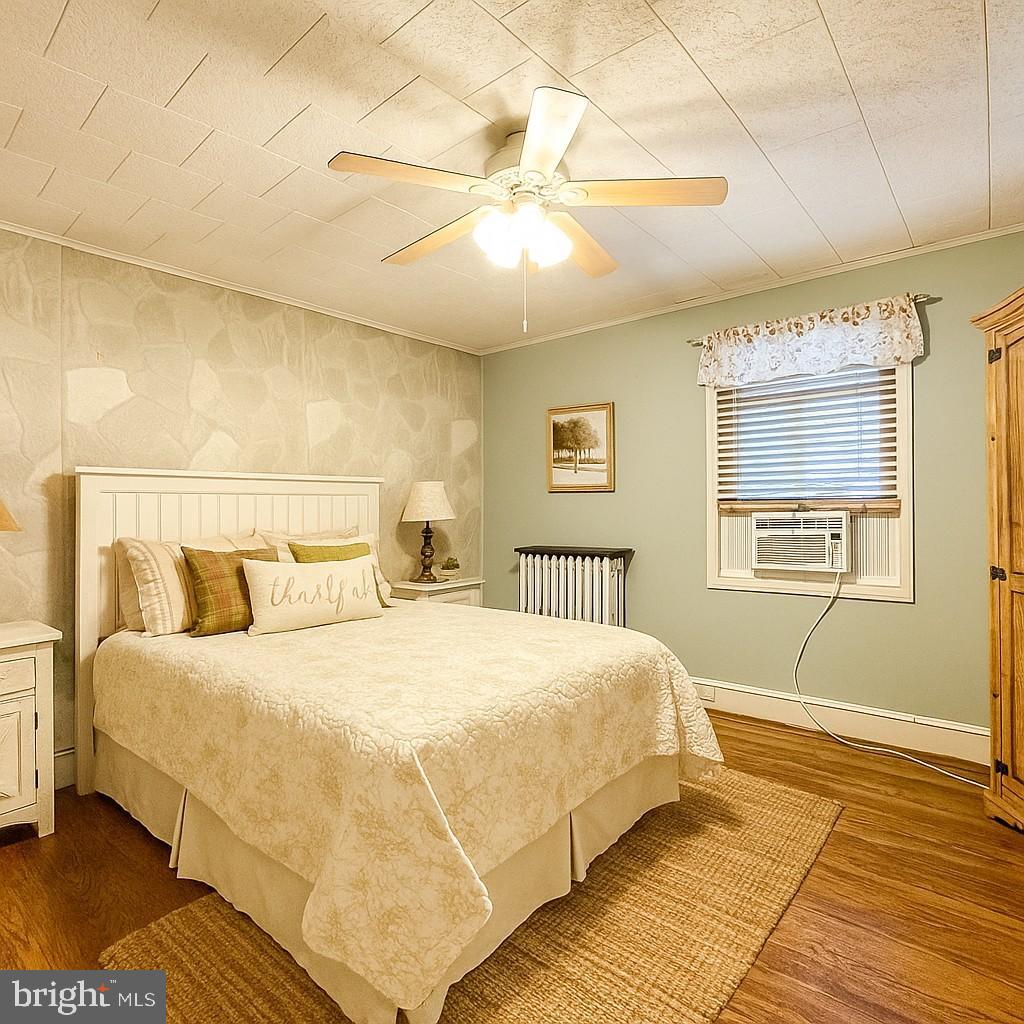 12812 New Row Rd N West Mount Savage, MD 21545 - Photo 24 of 32 a bedroom with a large bed and a window