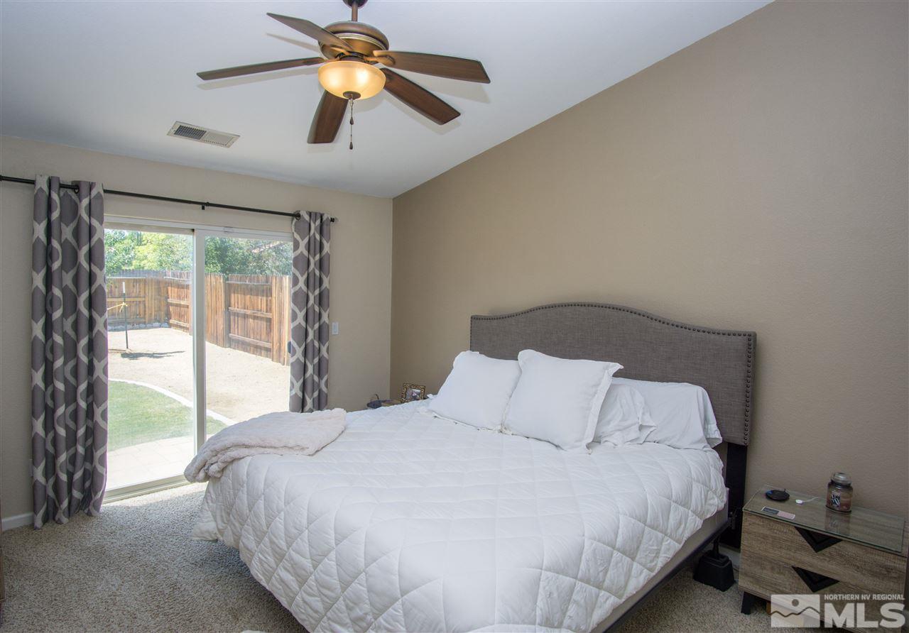 1736 River Gorge Court Reno, NV 89521 - Photo 14 of 23 a bedroom with a bed and a chandelier