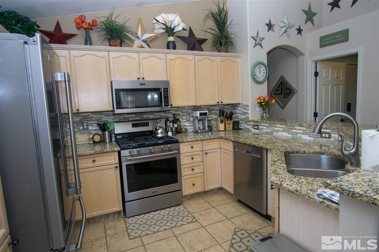1736 River Gorge Court Reno, NV 89521 - Photo 8 of 23 a kitchen with granite countertop a sink stove and refrigerator