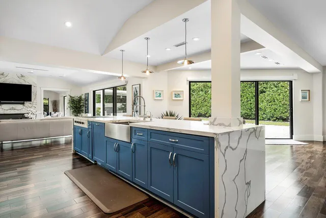 a bathroom with a granite countertop sink and a large window
