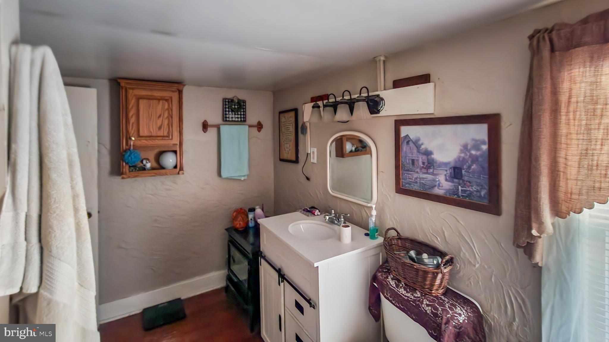 13614 Oldtown Road Southeast Cumberland, MD 21502 - Photo 17 of 30 a bathroom with a sink and a mirror