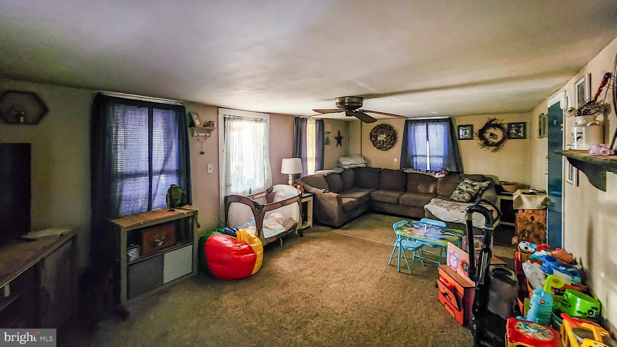 13614 Oldtown Road Southeast Cumberland, MD 21502 - Photo 3 of 30 a living room with furniture toys and a flat screen tv