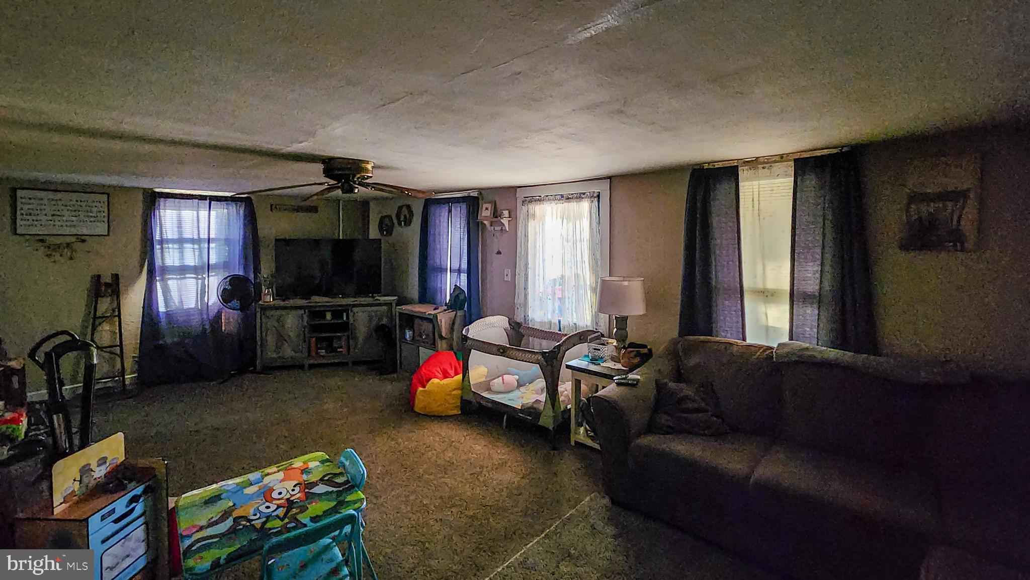 13614 Oldtown Road Southeast Cumberland, MD 21502 - Photo 5 of 30 a living room with furniture a flat screen tv and a window