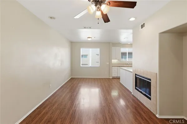 wooden floor in an empty room with a kitchen
