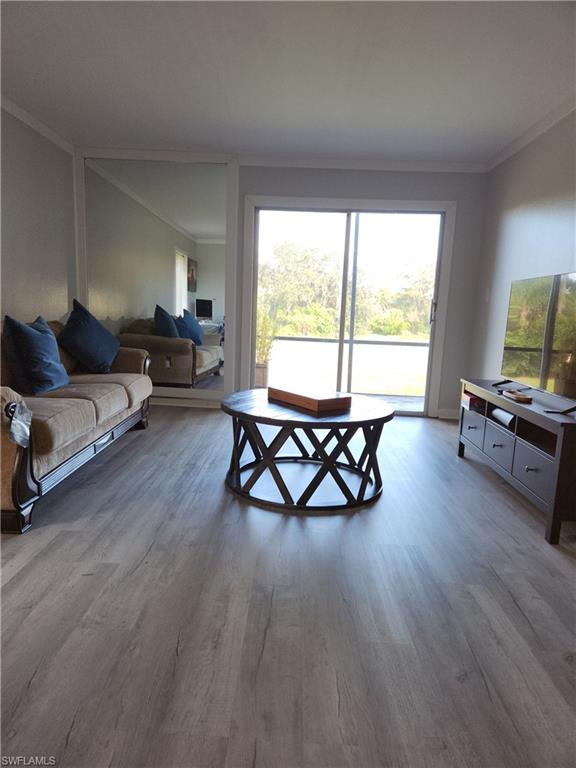 7141 Dell Road, Unit 3 New Port Richey, FL 34653 - Photo 4 of 12 a living room with furniture and a wooden floor