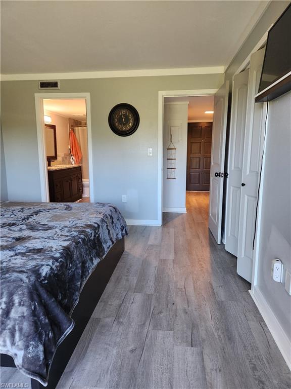 7141 Dell Road, Unit 3 New Port Richey, FL 34653 - Photo 7 of 12 a bedroom with a bed and a lamp on dresser