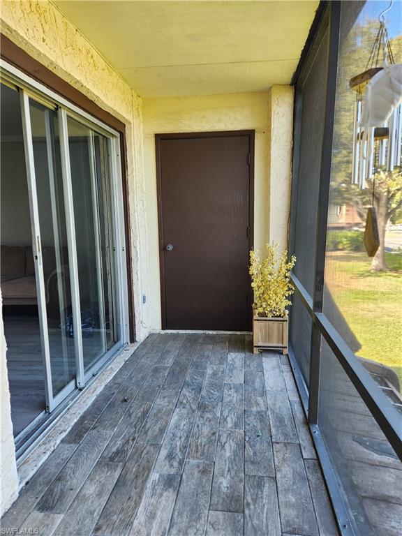 7141 Dell Road, Unit 3 New Port Richey, FL 34653 - Photo 10 of 12 a view of balcony with wooden floor