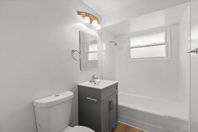 a bathroom with a sink toilet vanity and bathtub