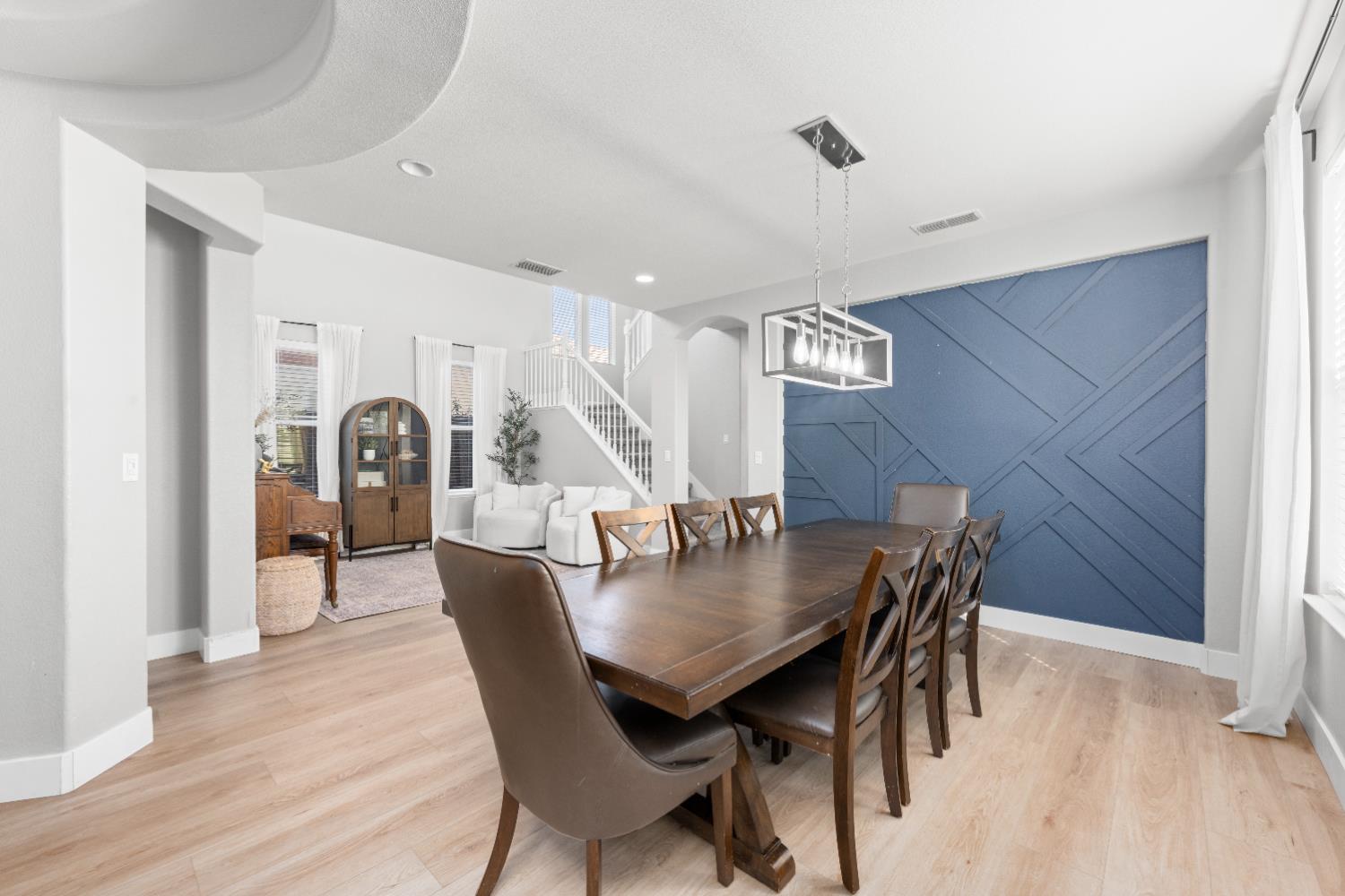 11749 Dionysus Way Rancho Cordova, CA 95742 - Photo 11 of 56 a view of a dining room with furniture and wooden floor