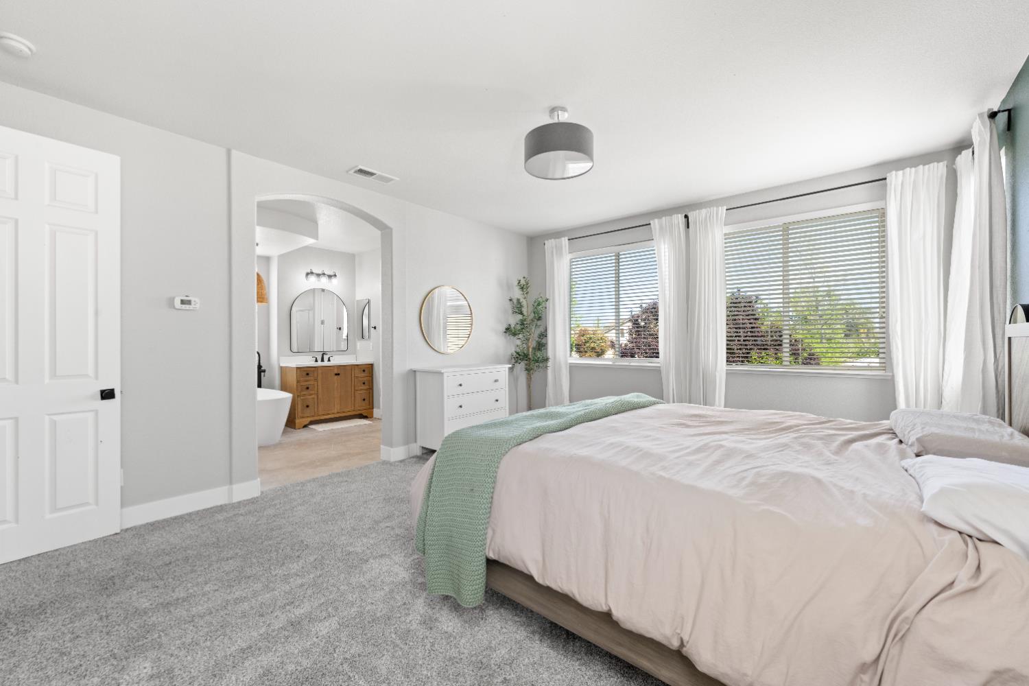 11749 Dionysus Way Rancho Cordova, CA 95742 - Photo 35 of 56 a bedroom with a large bed and a window