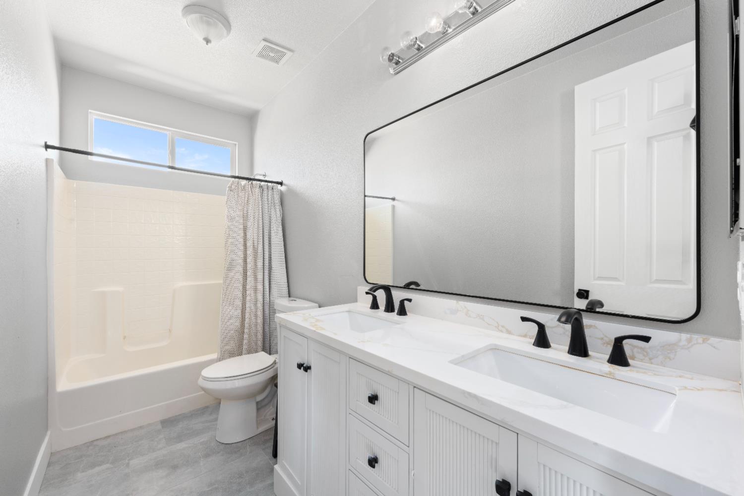 11749 Dionysus Way Rancho Cordova, CA 95742 - Photo 41 of 56 a bathroom with a double vanity sink toilet mirror and shower
