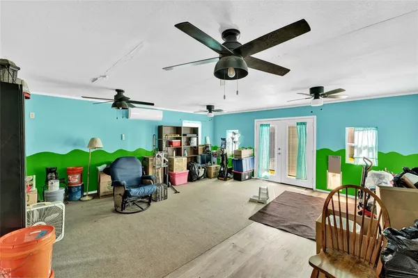 a view of a room with gym equipment and a large window