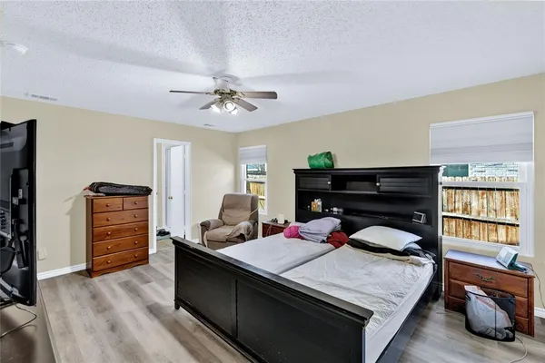 a bedroom with a bed closet and flat tv screen