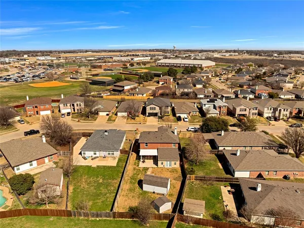 an aerial view of residential houses with outdoor space