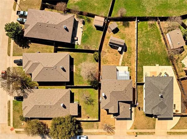 an aerial view of residential houses with outdoor space