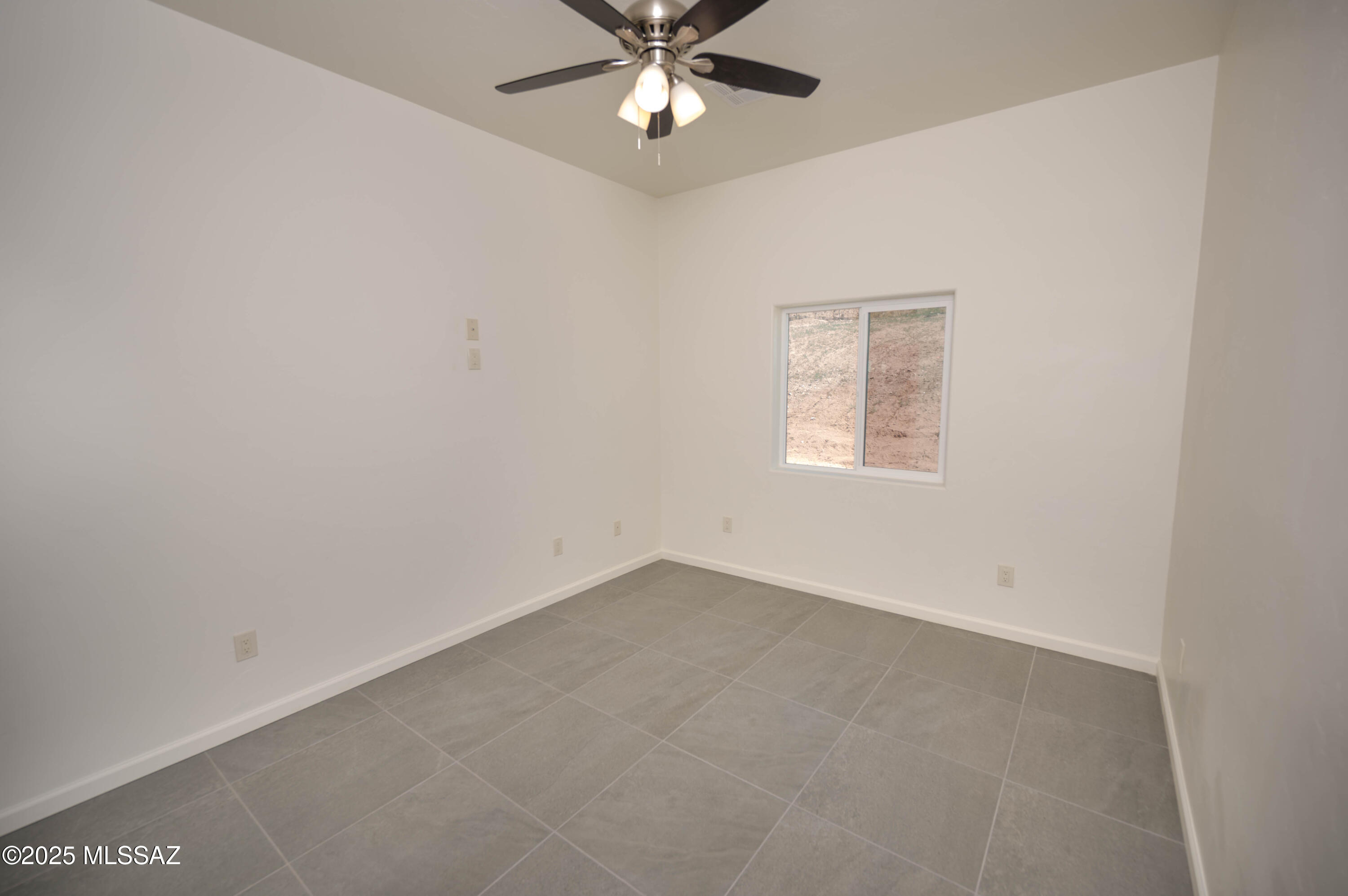 280 Donna Court Rio Rico, AZ 85648 - Photo 26 of 50 an empty room with a window and a fan