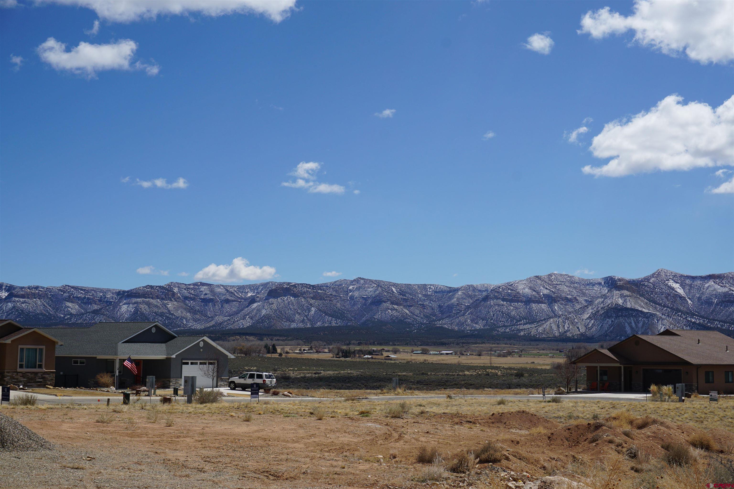 1101 Bluffs Boulevard Cortez, CO 81321 - Photo 8 of 10 a front view of a house with a mountain