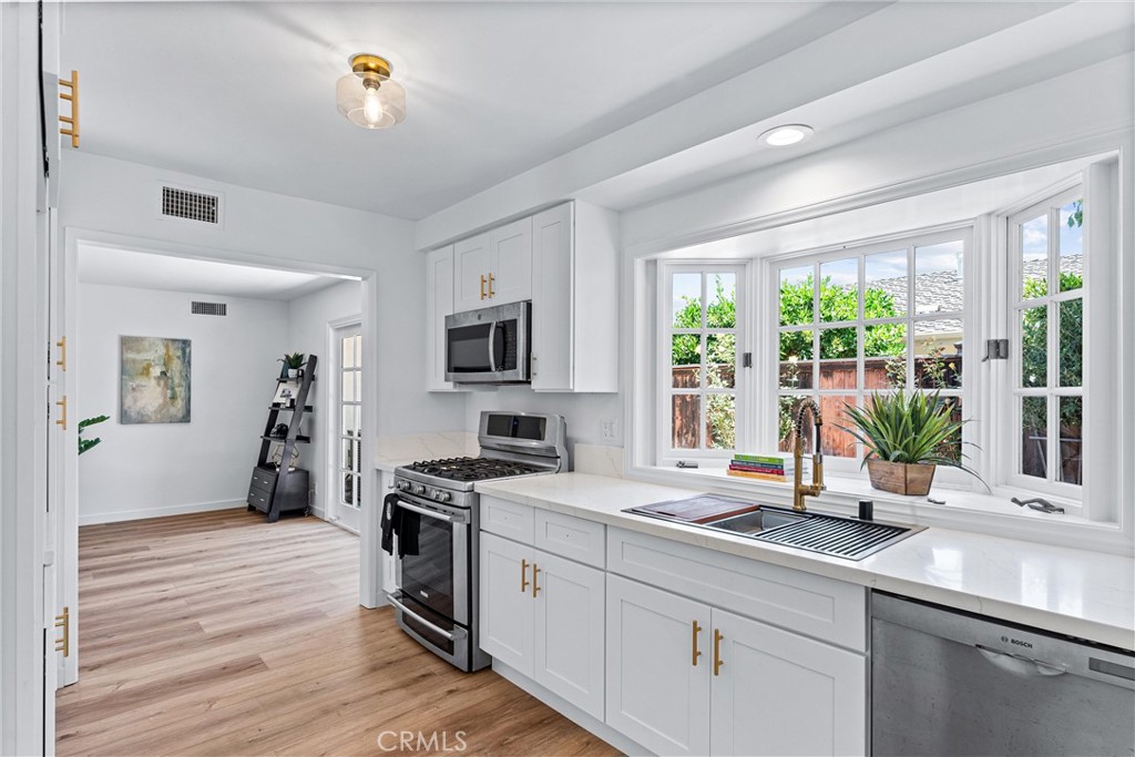 29 Bethany Drive Irvine, CA 92603 - Photo 16 of 44 a kitchen with a sink appliances and a counter top space