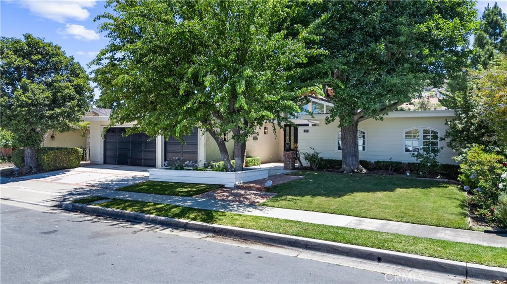29 Bethany Drive Irvine, CA 92603 - Photo 2 of 44 a front view of a house with a yard and a garage